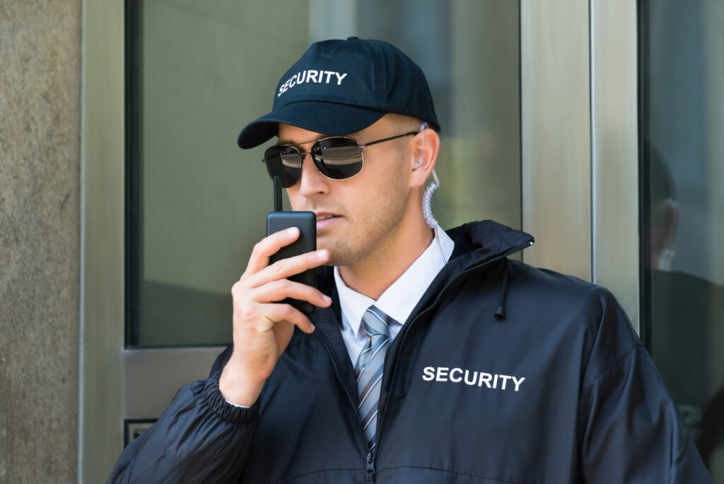 4 Things To Remember When Choosing a Security Provider 1 Portrait Of Young Security Guard Using Walkie-talkie Radio
