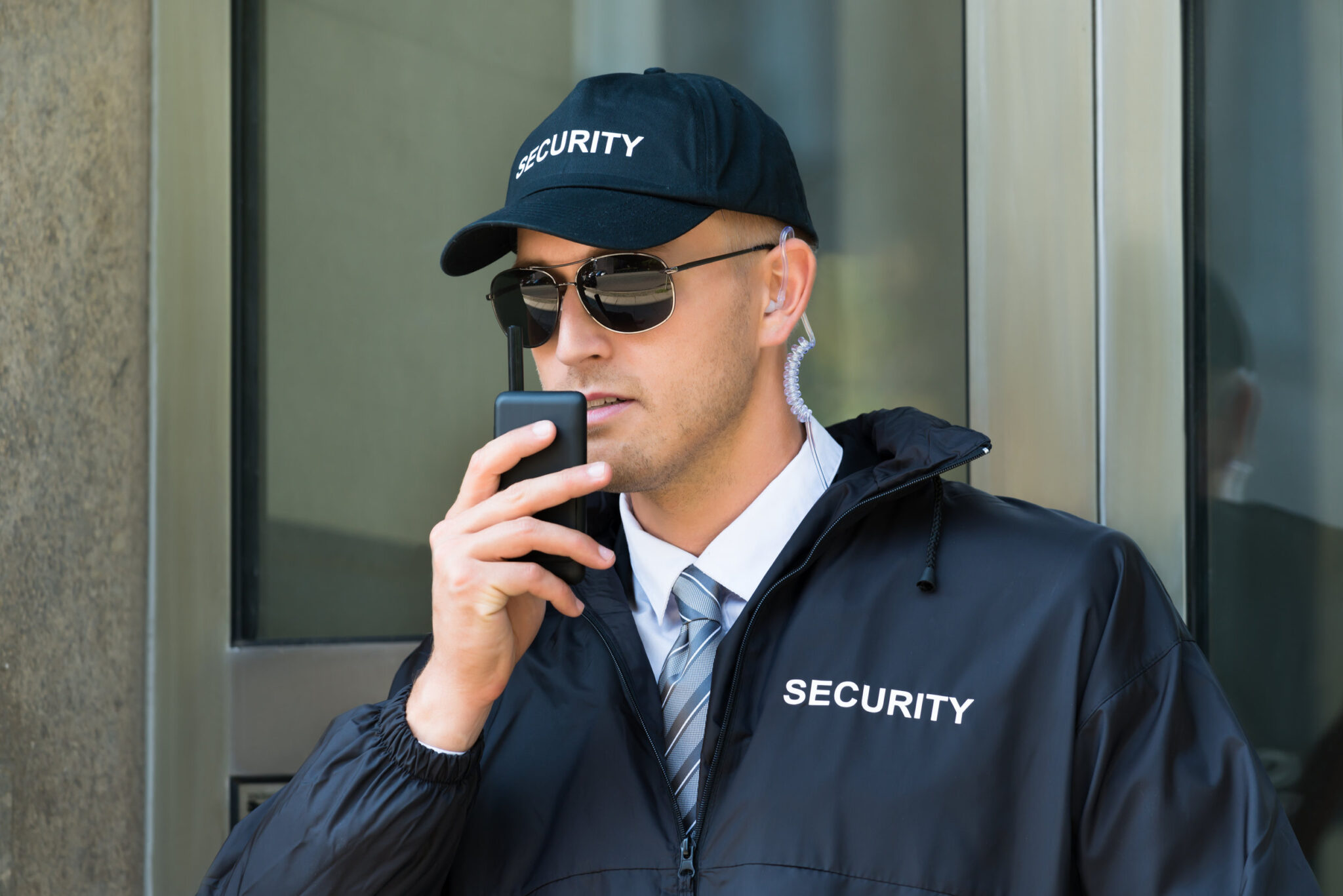 Blog 2 Portrait Of Young Security Guard Using Walkie-talkie Radio